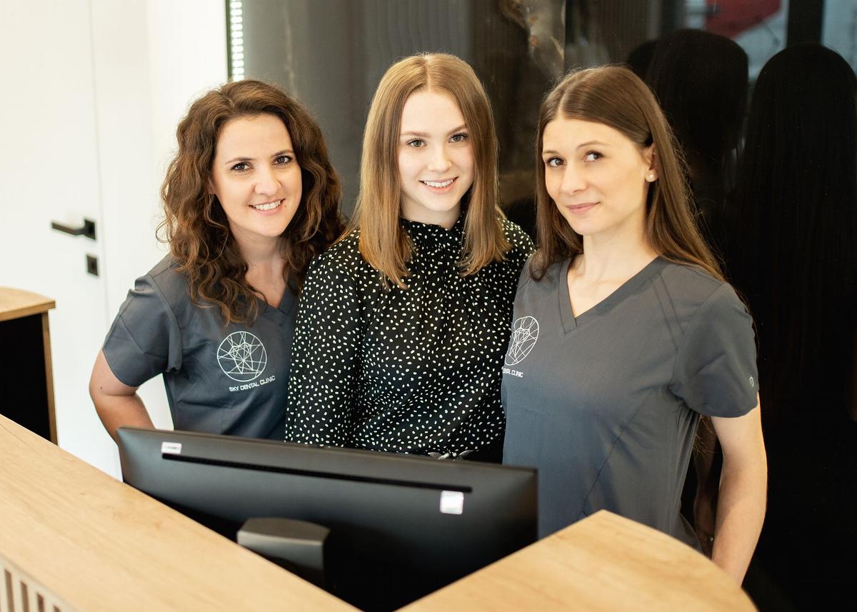 Three standing women - employees of Sky Dental Clinic